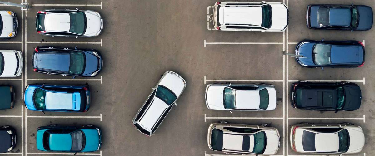 The only vacant parking space in parking lot. Navigation in the car park. Searching for vacant space for parking. The parking is jammed with cars. problem. Finding a vacant place.