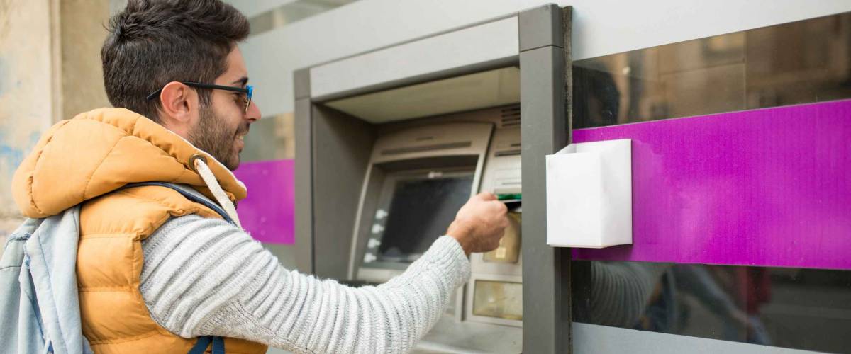 The tourist withdraws money from the ATM for further travel. Finance, credit card, withdrawal of money. Life style. Journey. Vacation.