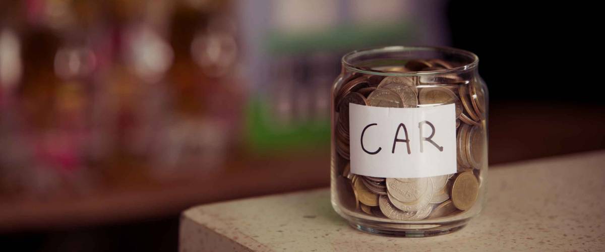 save money.save money concept.save money in glass money jar with car label.