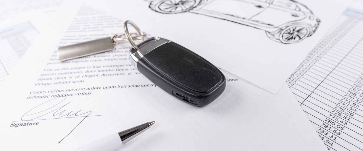 Car keys on the signed agreement document