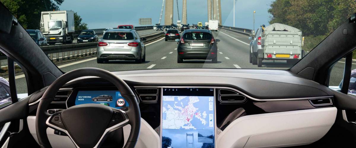 Self driving car on a road. Autonomous vehicle. Inside view.