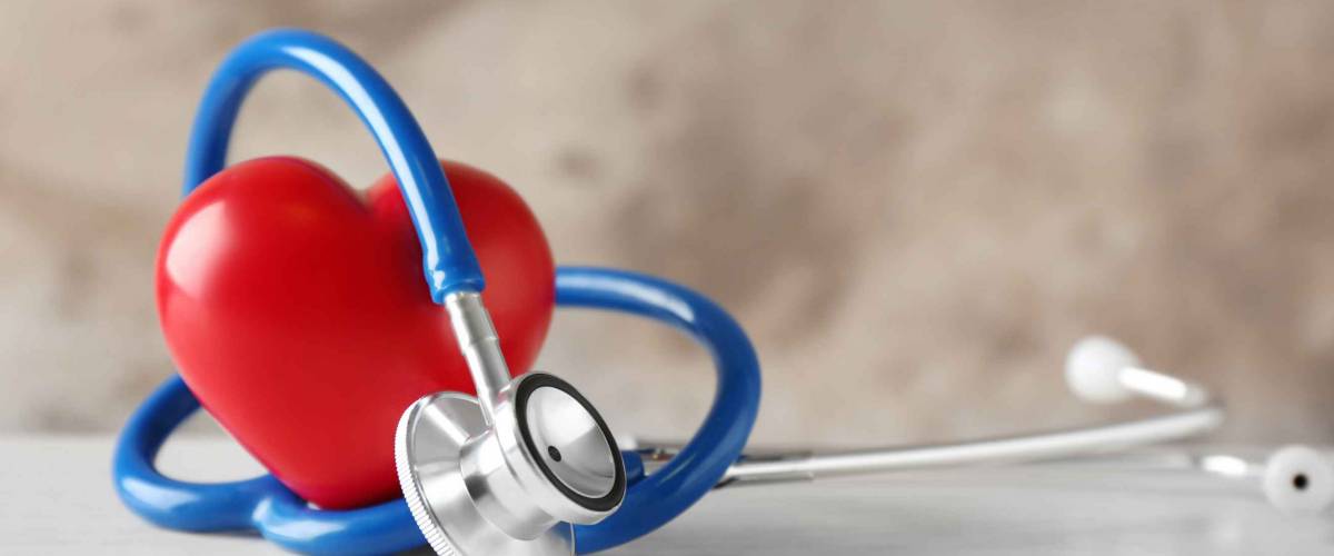 Stethoscope and red heart on table