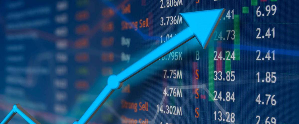 Stock market rise with blue arrow and faded candlestick charts. Winning and success emotion and happiness.