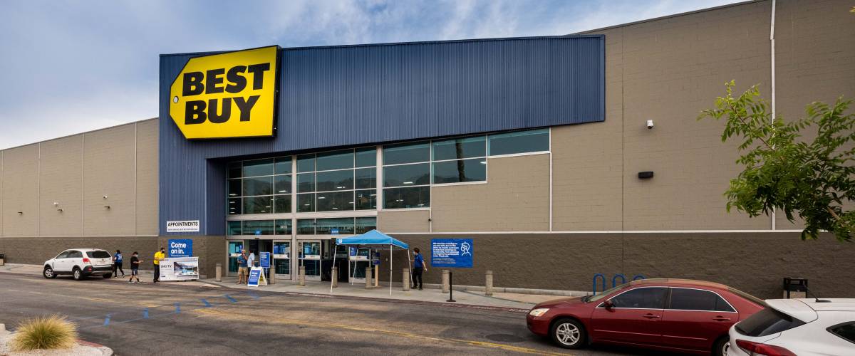 Best Buy store with cars driving past