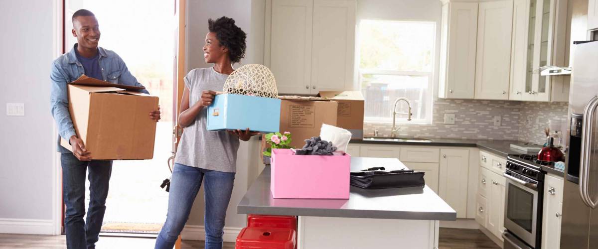Young Couple Moving In To New Home Together