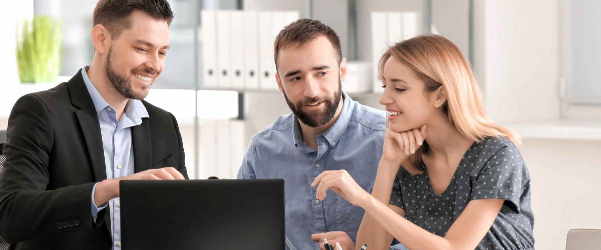 Businessman consulting young couple in office