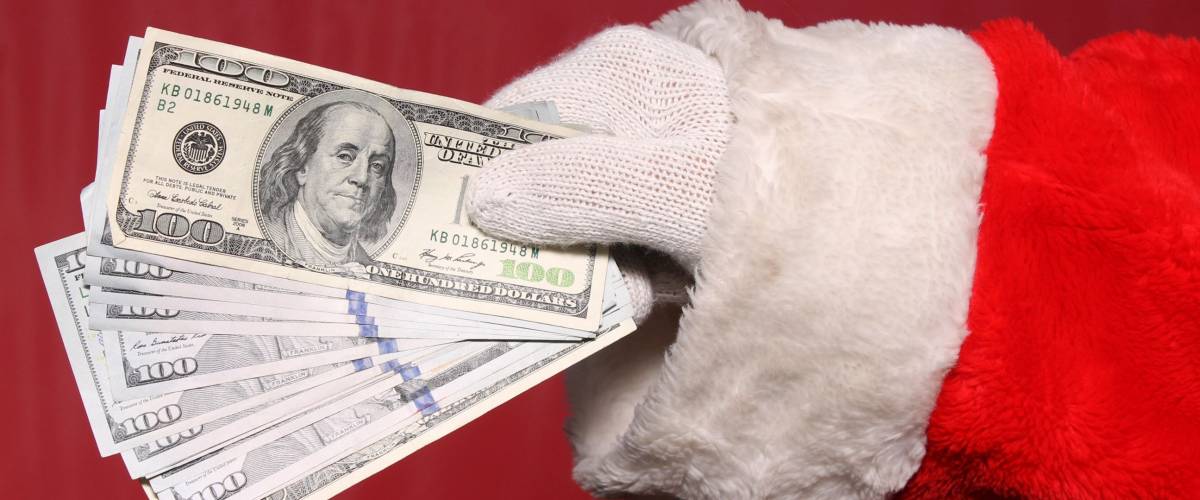 Santa Claus holds Christmas Cash. American Money in Santa's Hand.