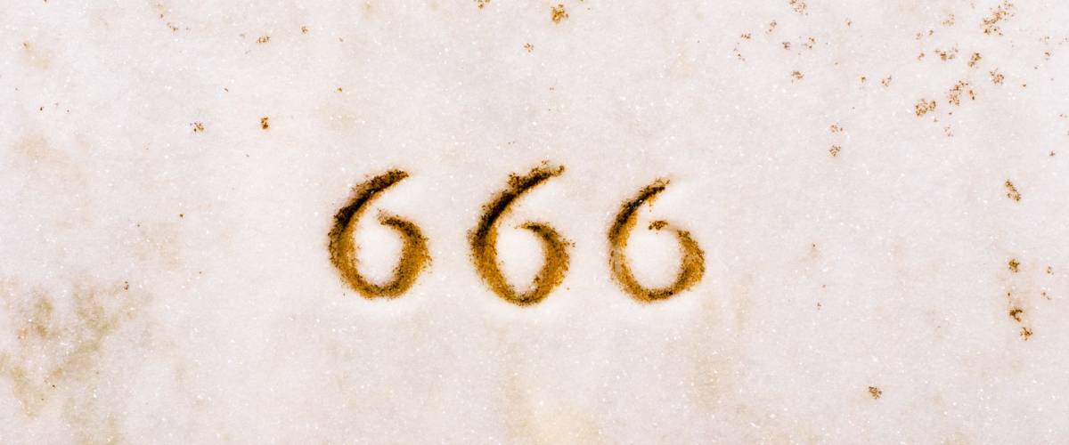 Closeup of 666 engraved in headstone
