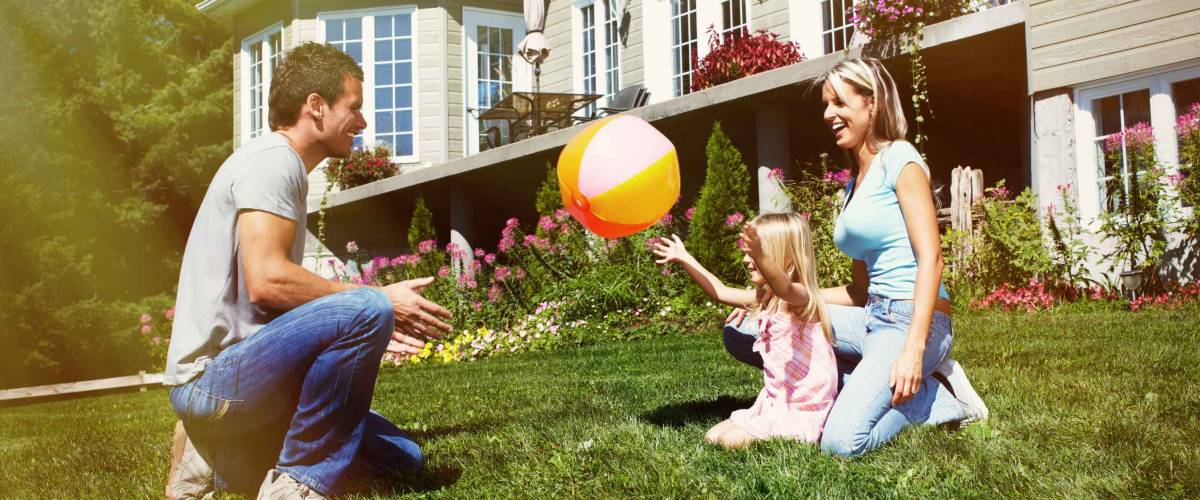 Happy smiling family with child over house background