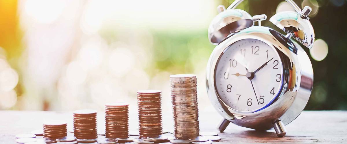 Close up of time and money with green bokeh background ,Business Finance and Money concept,Save money for prepare in the future.time is money concept
