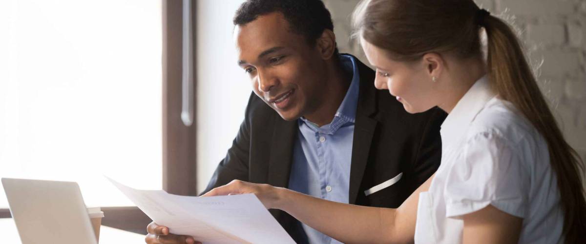 Female financial advisor insurer banker consulting male african american client about contract, caucasian mentor hr and black intern new employee discussing documents at meeting advice