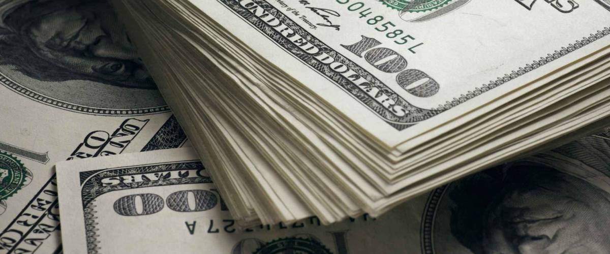Stack of one hundred dollar bills close-up.