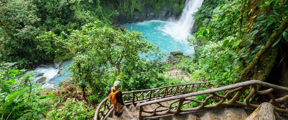 Majestic waterfall in the rainforest jungle of Costa Rica. Tropical hike.