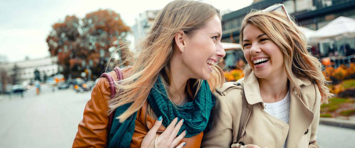 Happy friends shopping. Two beautiful young women enjoying shopping in the city.
