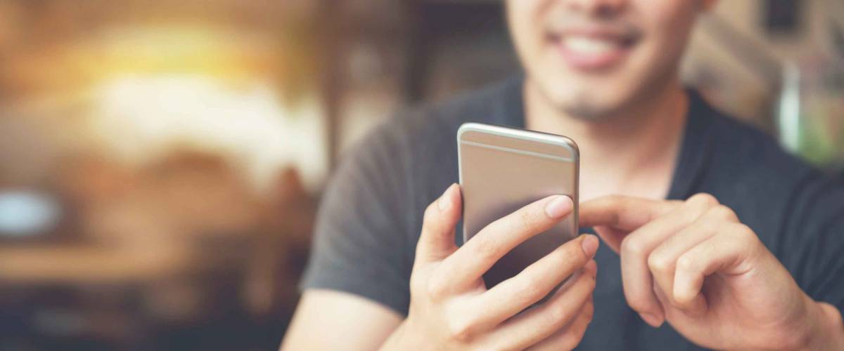 Happy male using smartphone