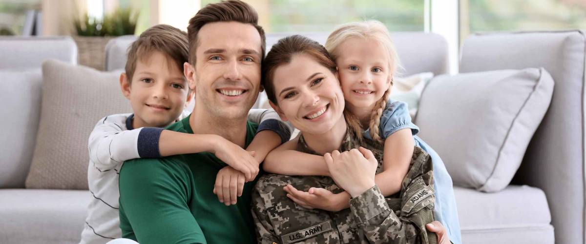Woman in military uniform with her family at home