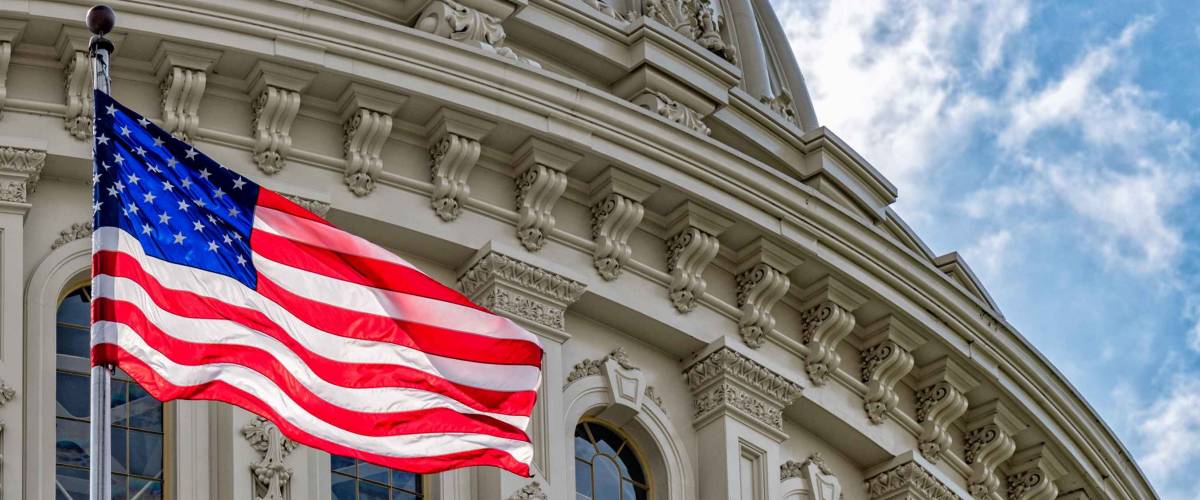 Washington DC Capitol dome detail with waving american flag
