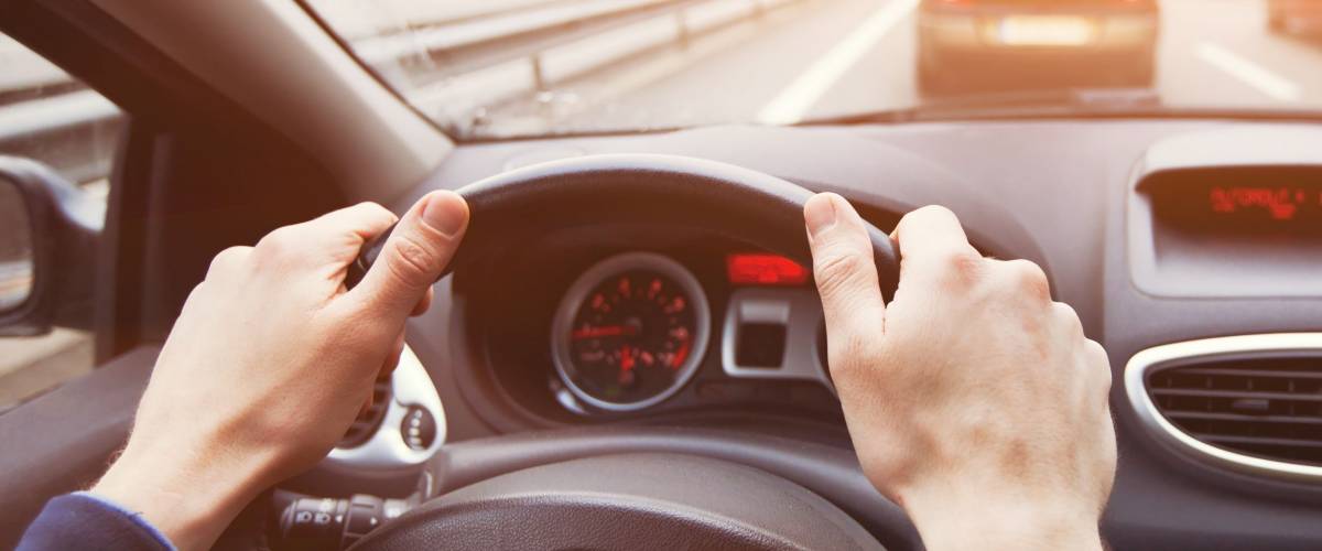 traffic jam, driving car on highway, close up of hands on steering wheel in sunny day