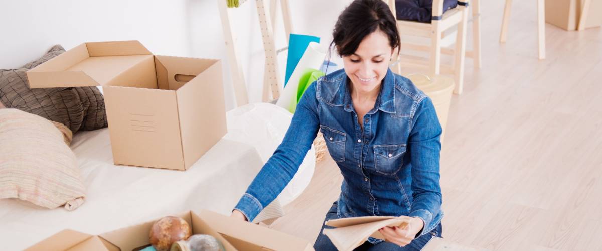 Young woman moving into a new apartment.