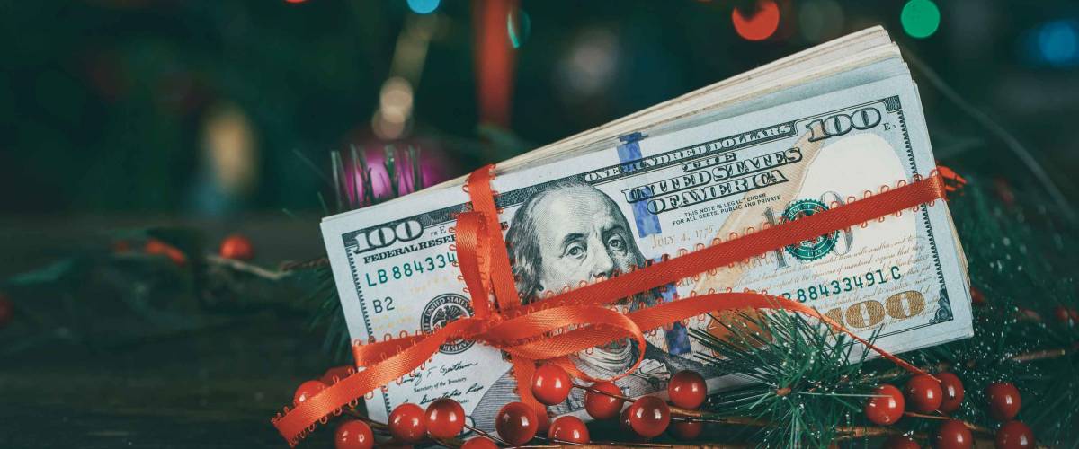 American dollars as a Christmas gif t or a Christmas spending concept