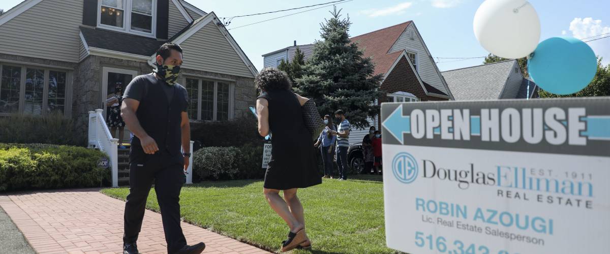 Open house during pandemic, people wearing face masks walking in and out of house