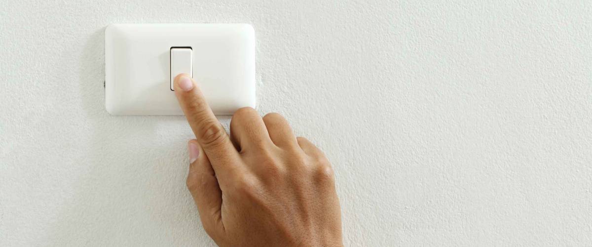 closeup of hand touching electric-switch