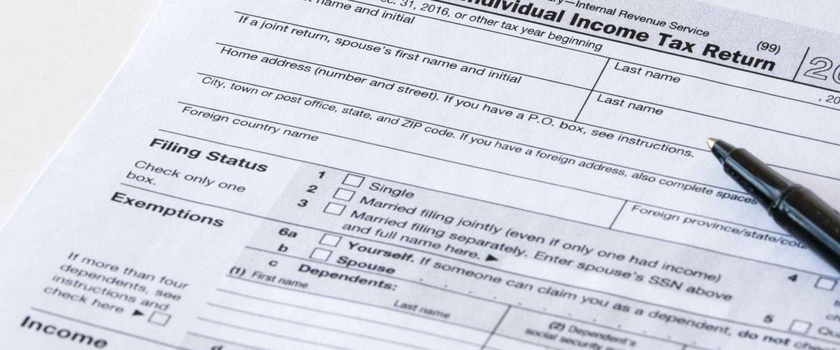 income tax claim paper with pen on top of it