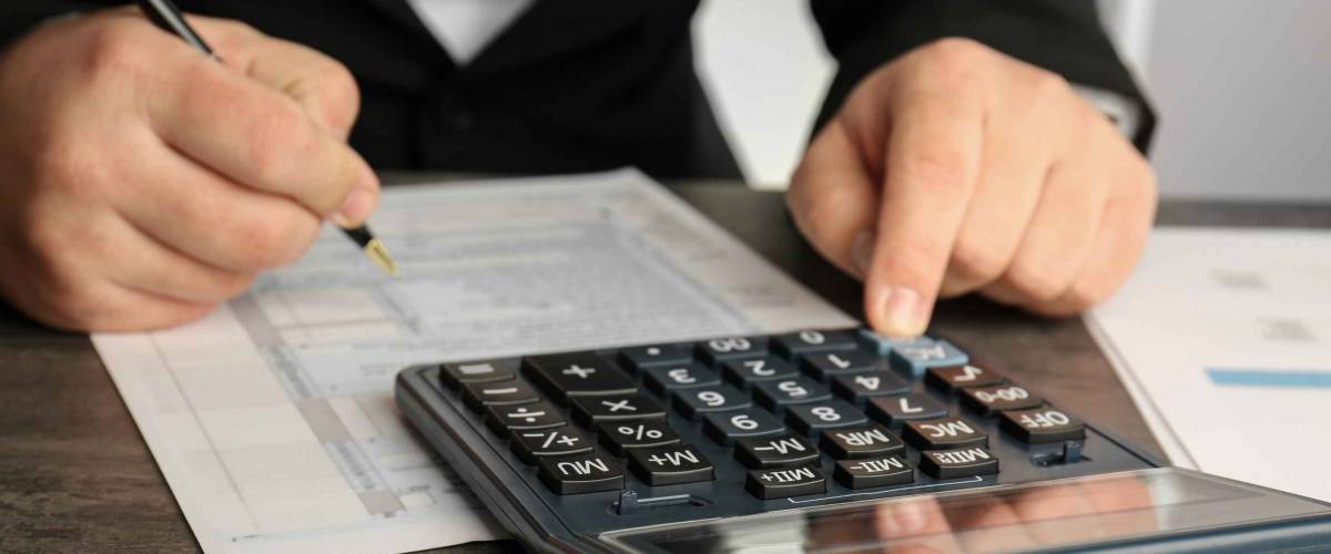 man with a calculator and tax bill
