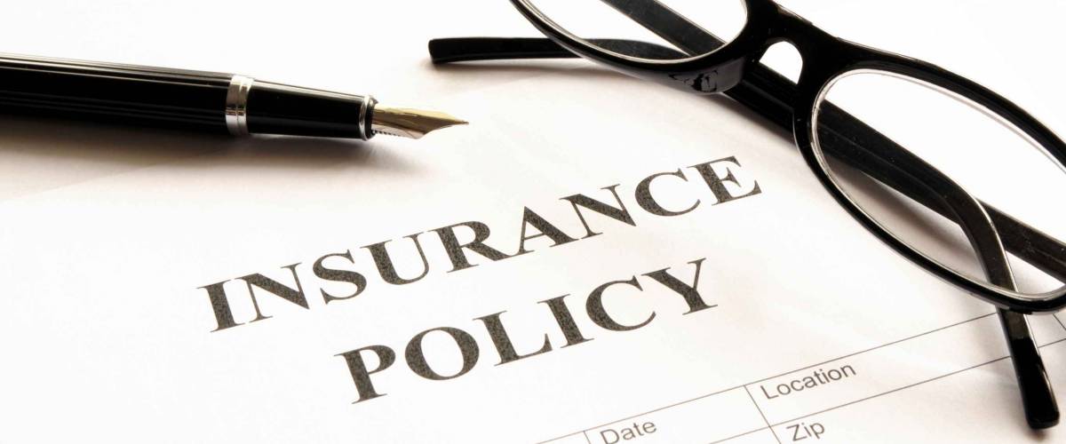 insurance policy form on desk in office showing risk concept