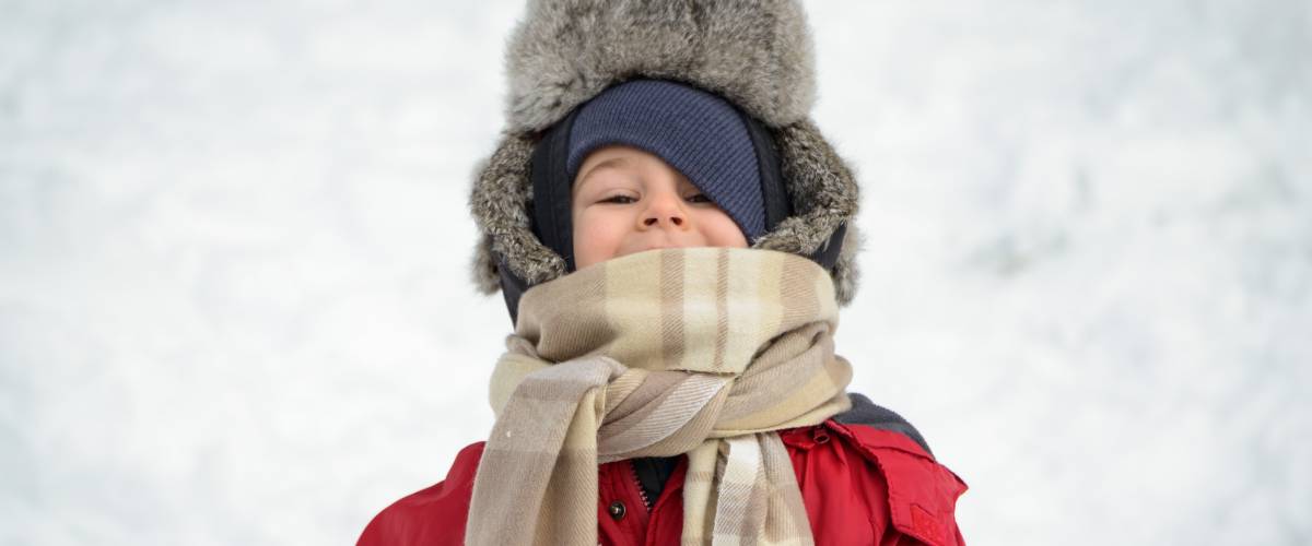 Boy bundled up for the winter with jacket scarf and hat