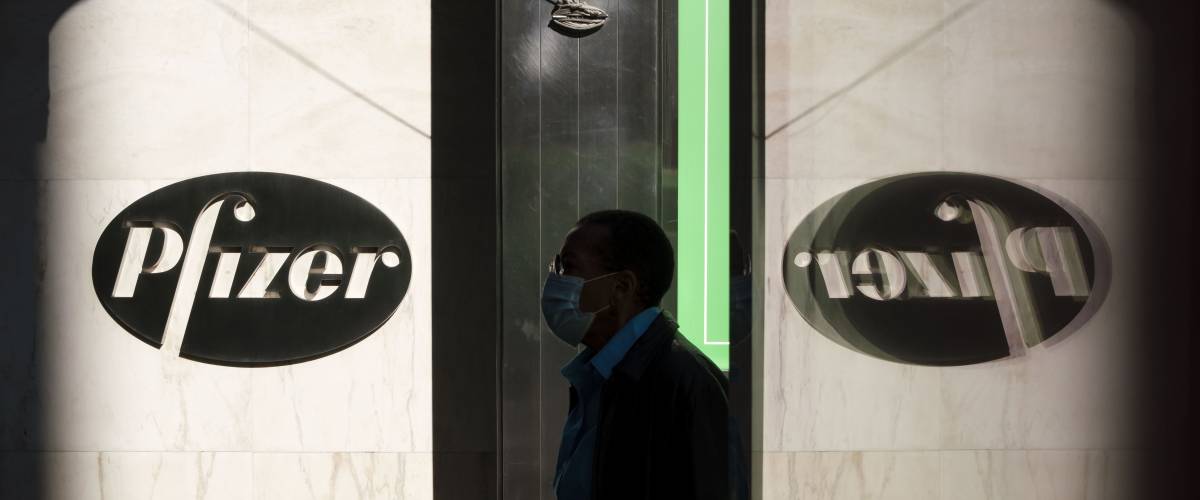 Man walks past Pfizer building