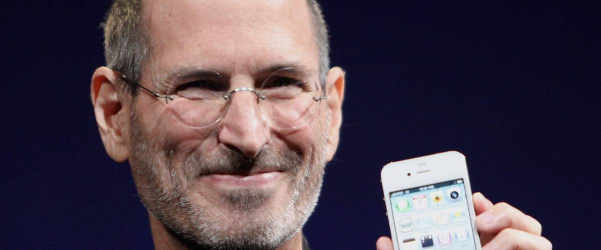 Steve Jobs closeup holding an iPhone