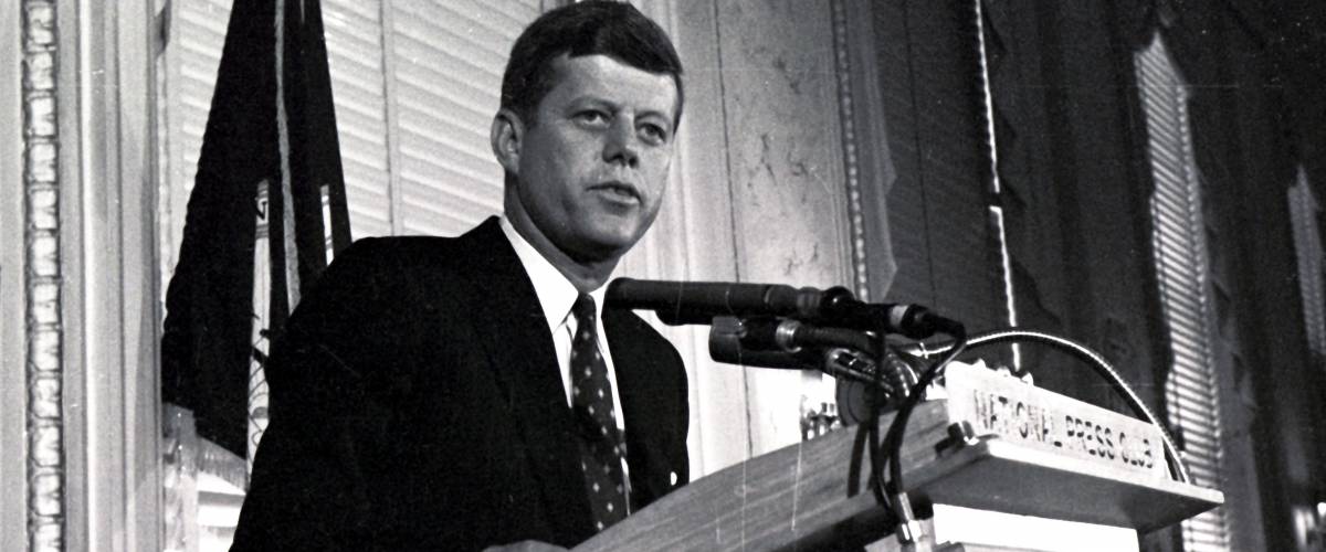 President John F. Kennedy speaks on stage