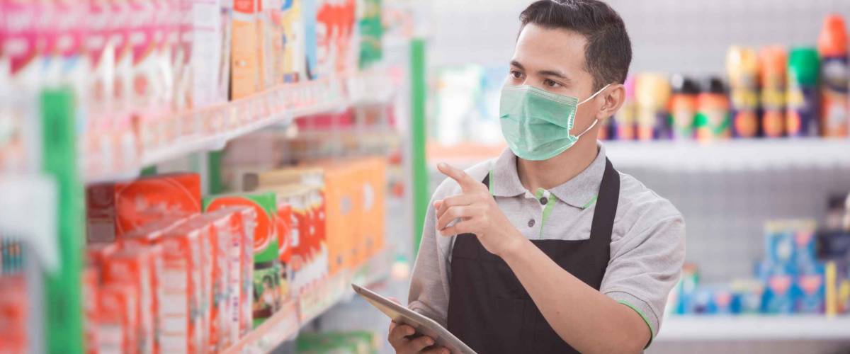 male shopkeeper working in a grocery store