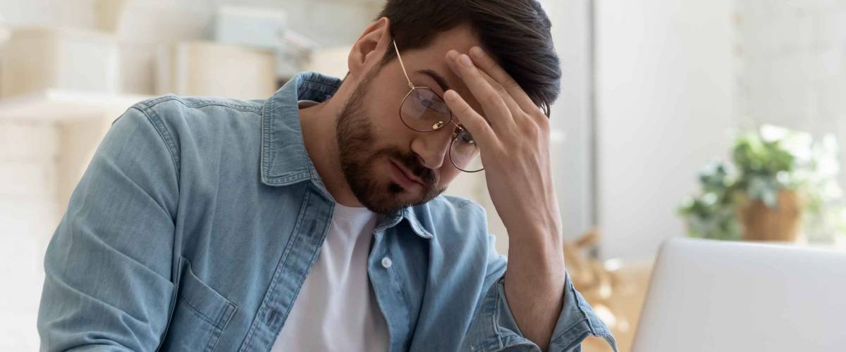 Frustrated young man reading bad news
