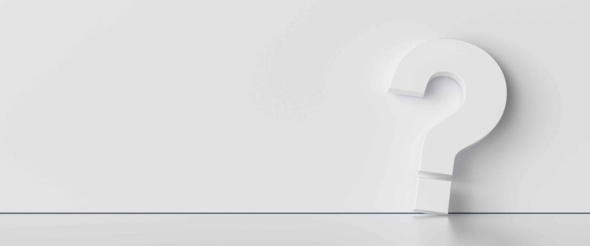 Question mark on white wall background - FAQ Concept image