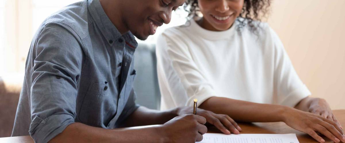 happy couple sign paper