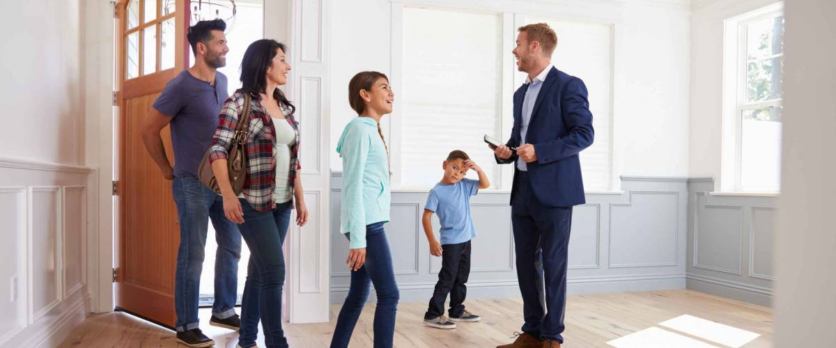 real estate agent shows family a home