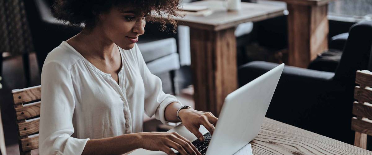 young woman with hands on laptop keyboard