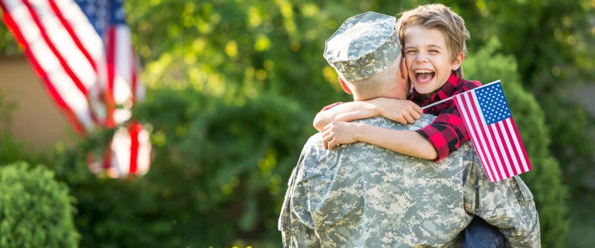 Happy reunion of soldier with family, son hug father