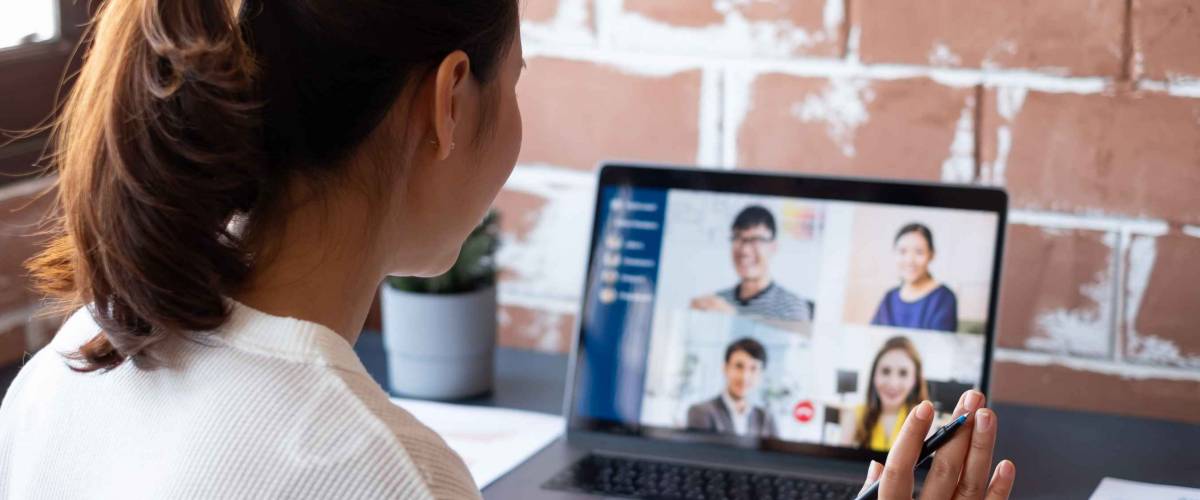 Young Asian businesswoman work at home and virtual video conference meeting with colleagues business people, online working, video call due to social distancing at home office