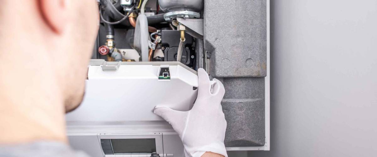 close up of technician looking at furnace system