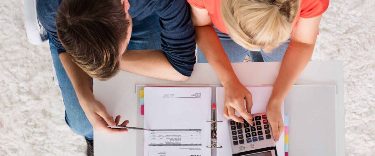 Couple Using Calculator, seen from above