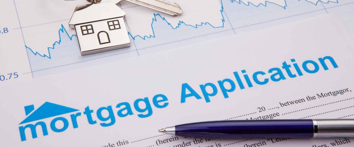 An empty mortgage application form with house key