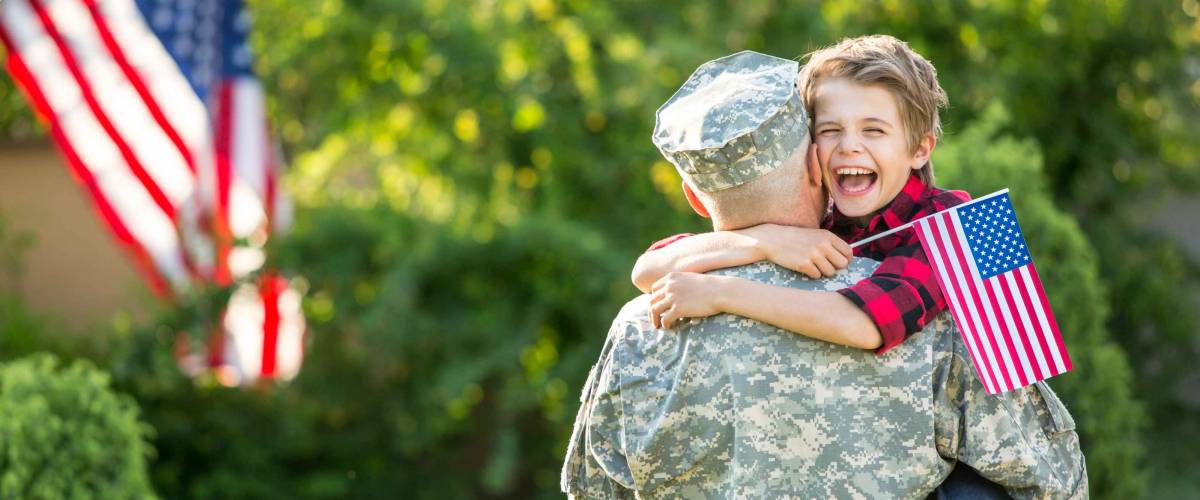 Happy reunion of soldier with family, son hug father