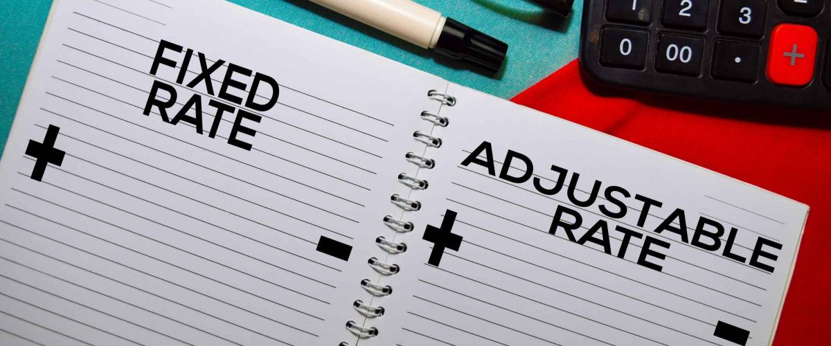 Fixed Rate and Adjustable Rate text on a book isolated on office desk.