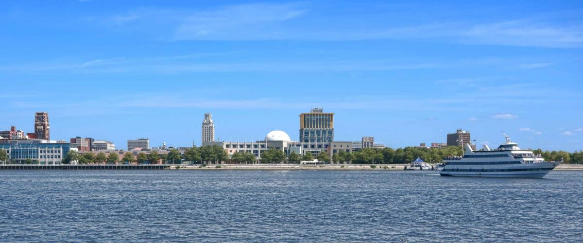 Camden New Jersey waterfront cityscape wide scenic view panorama with cruise boat from across the Delaware River from Philadelphia