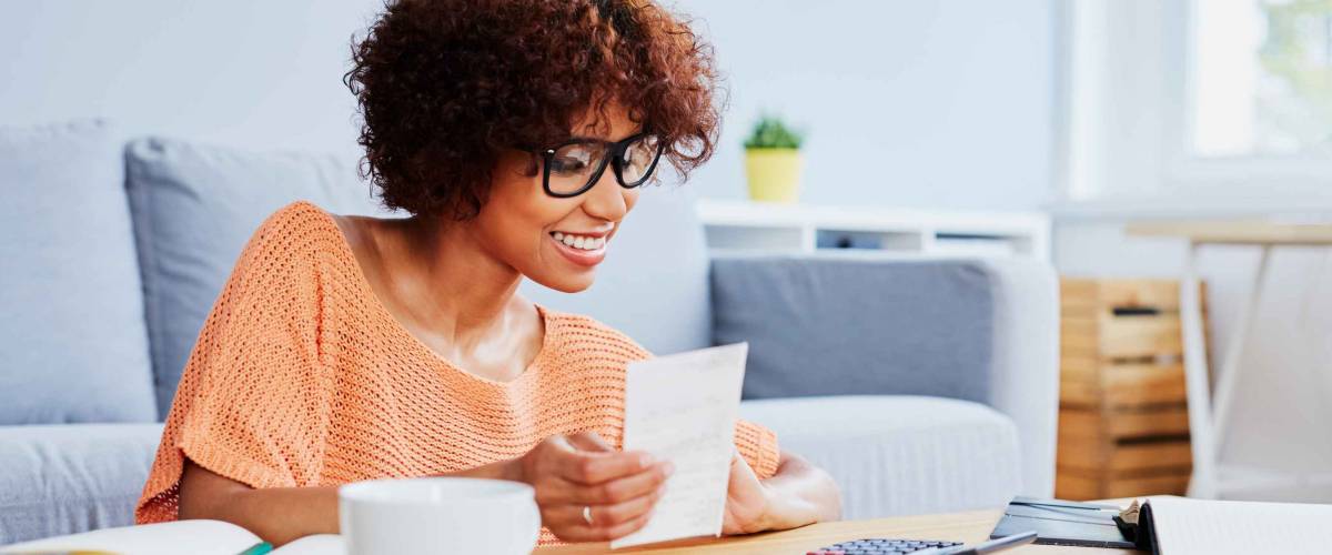Young woman calculating home finances, paying bills