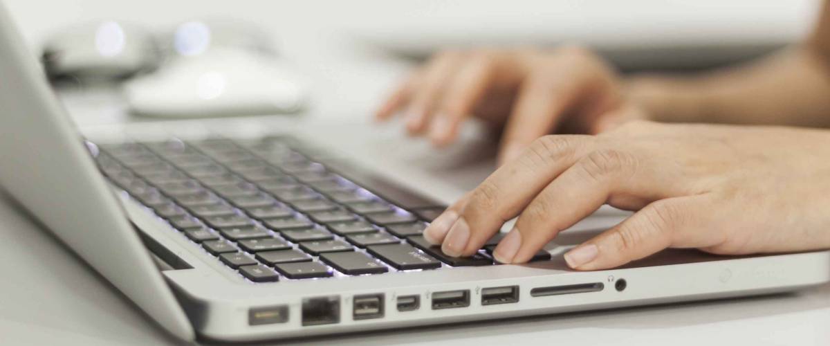 Female office worker typing on the keyboard