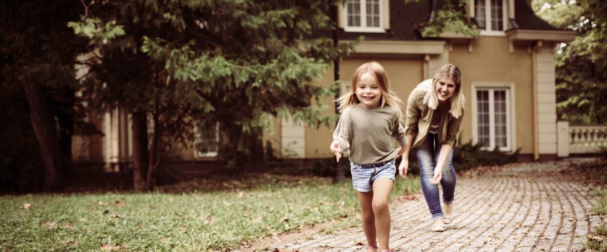 Mom and daughter playing outside of home